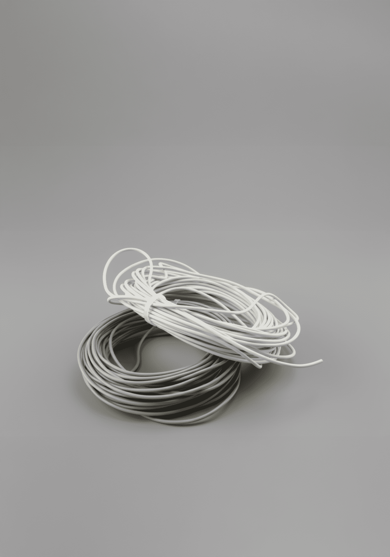 Deux bobines de câbles électriques, l’une blanche et l’autre grise, enroulées et posées côte à côte.